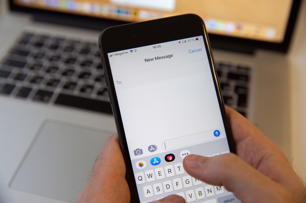 Person Sending Text Message Or iMessage On iPhone