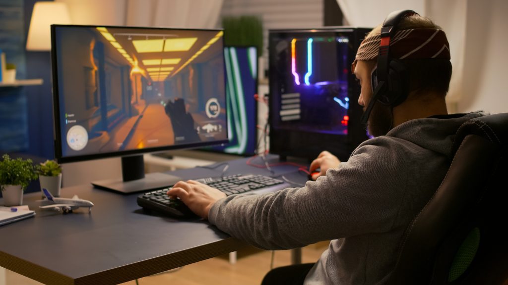 Person Playing Video Games On Gaming PC